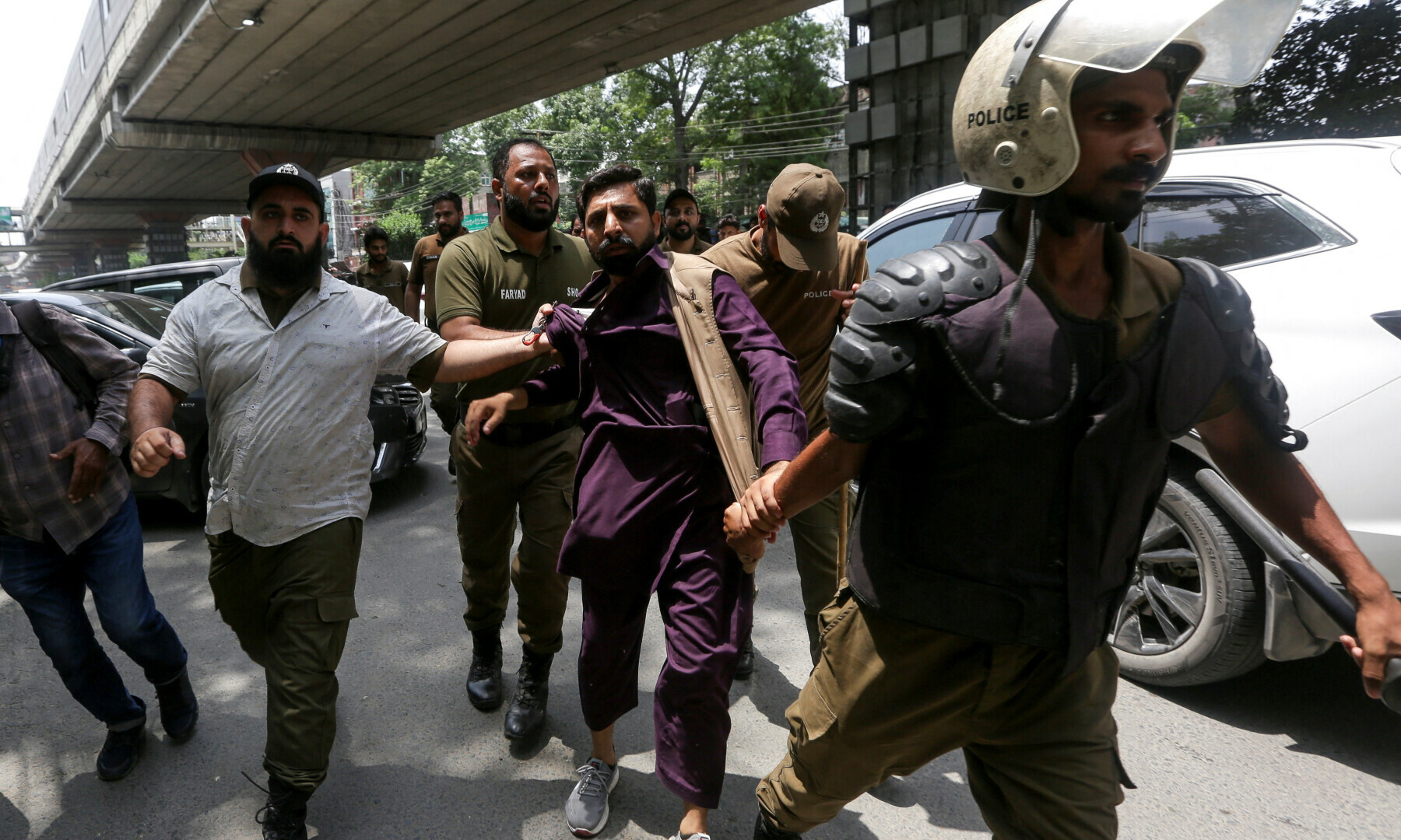 A PTI supporter is being detained by police officers during a nationwide protest demanding Imran Khan’s release on the second anniversary of his arrest, in Lahore on Aug 5, 2025. — Reuters/Mohsin Raza