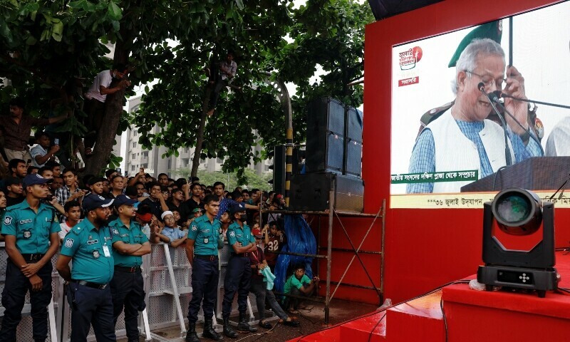 People watch Muhammad Yunus, leader of Bangladeshi interim government, as he appears on a screen while reading the July Declaration, during celebrations marking the one-year anniversary of student-led protests that led to the ousting of Bangladeshi then-prime minister Sheikh Hasina, at Manik Mia Avenue, outside the parliament building, in Dhaka, Bangladesh, August 5. — Reuters People watch Muhammad Yunus, leader of Bangladeshi interim government, as he appears on a screen while reading the July Declaration, during celebrations marking the one-year anniversary of student-led protests that led to the ousting of Bangladeshi then-prime minister Sheikh Hasina, at Manik Mia Avenue, outside the parliament building, in Dhaka, Bangladesh, August 5. — Reuters