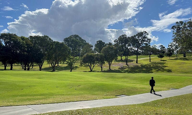 A man walks at the Victoria Park-Barrambin, where the main stadium will be built for the 2032 Olympics, in Brisbane, Australia July 21, 2025. &mdash; Reuters/File