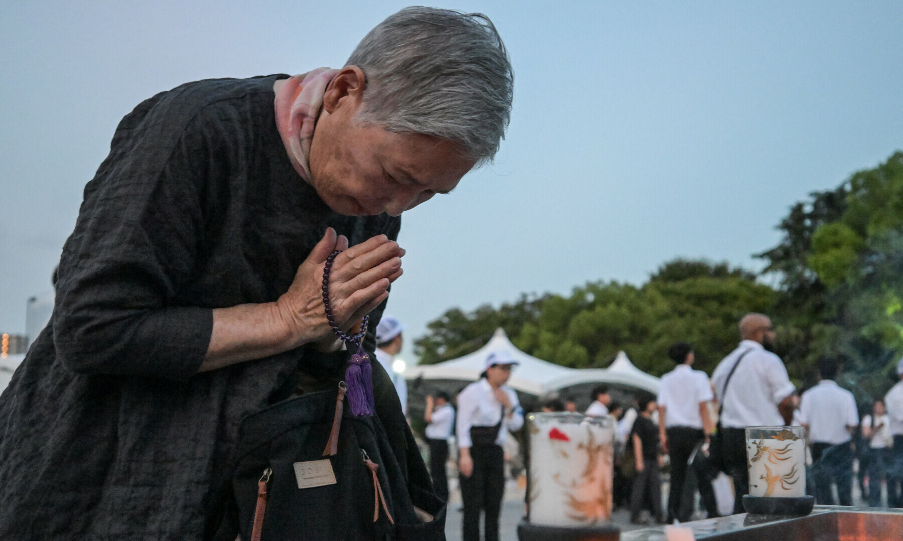 A woman prays at the Peace Memorial Park ahead of the memorial service to mark the 80th anniversary of the world’s first atomic bomb attack, in the city of Hiroshima early on August 6, 2025. — AFP