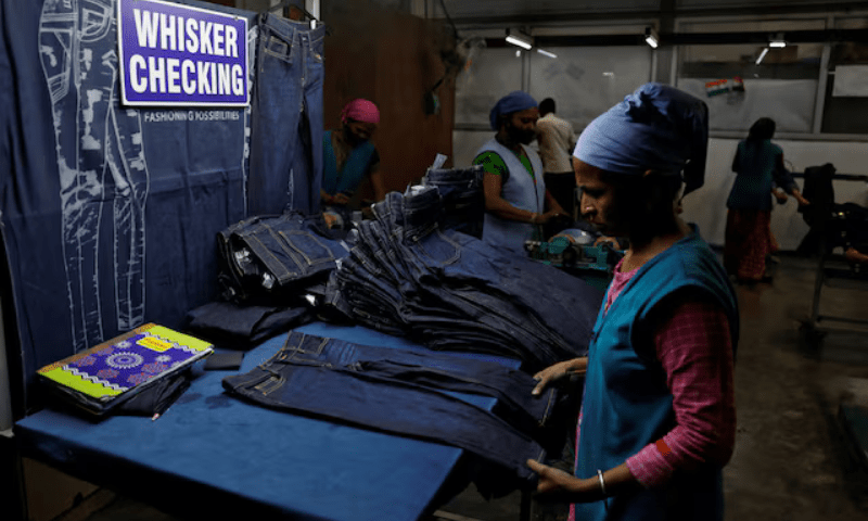 A worker makes final checks on jeans pants before packaging in a garment manufacturing unit on the outskirts of Ahmedabad, India on August 5, 2025. &mdash; Reuters
