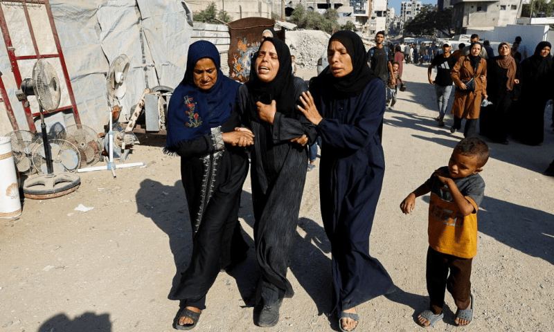 Women mourn on the day of the funeral of Palestinians who were killed by Israeli fire while trying to receive aid on Tuesday, according to medics, outside the Al-Shifa Hospital, in Gaza City on Aug 6, 2025. — Reuters
