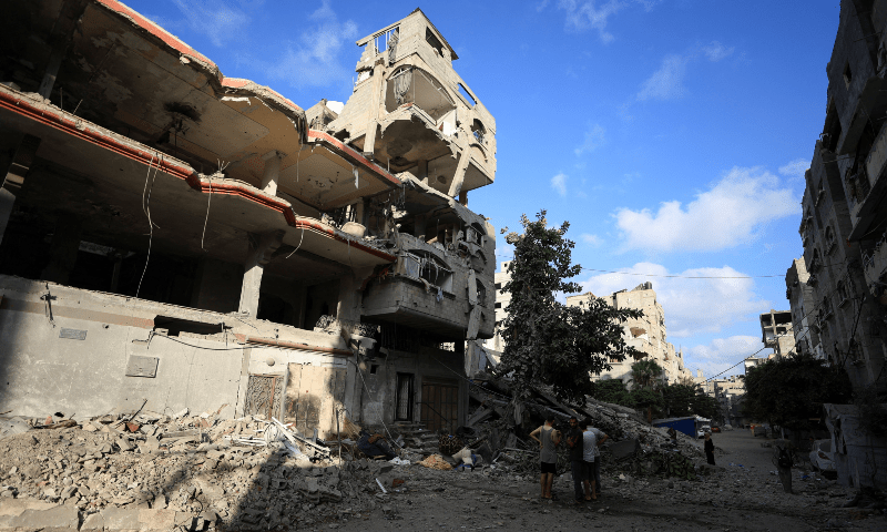 Palestinians inspect the site of an overnight Israeli strike on a house in Gaza City on August 7, 2025. &mdash; Reuters