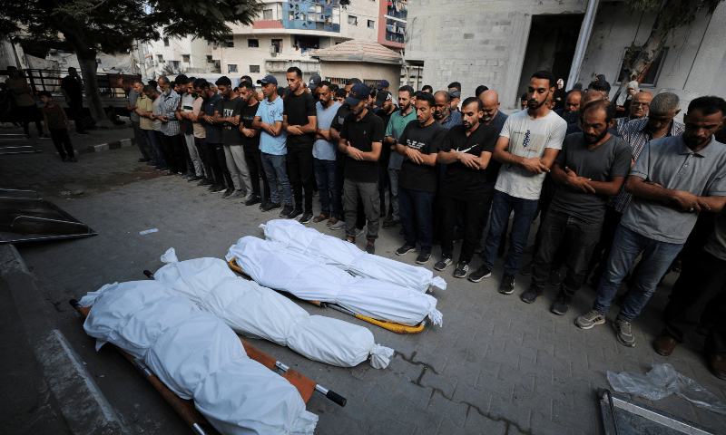 Mourners pray next to bodies during the funeral of Palestinians killed in an overnight Israeli strike, in Gaza City on August 7, 2025. — Reuters