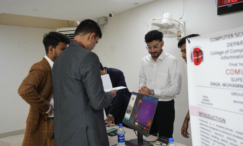 Participants show their final year project to judges at IoBM in Karachi on July 27. &mdash; Photo via author