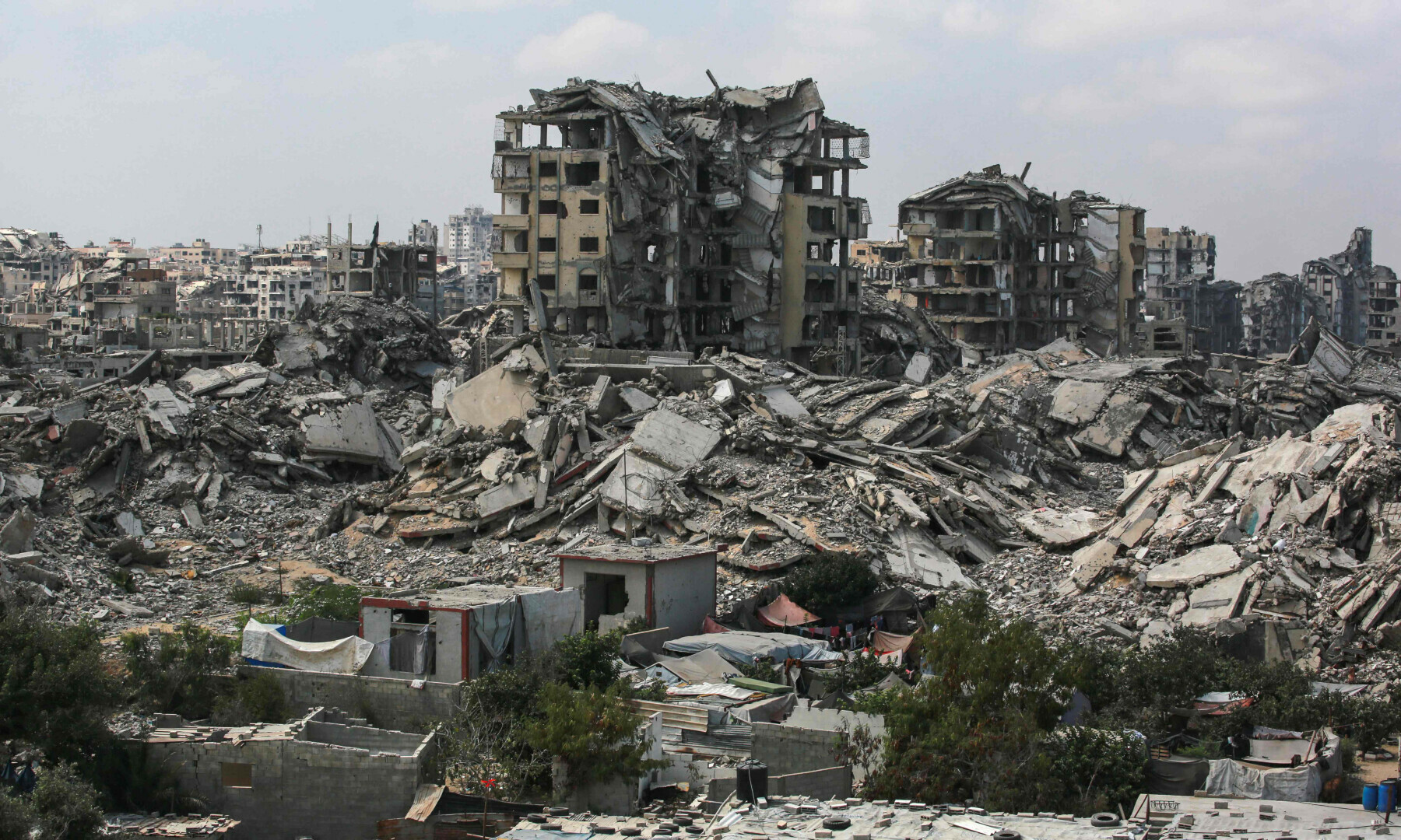  Buildings destroyed in Israeli strikes surround makeshift shelters for displaced Palestinians in Gaza City on August 8, 2025. &mdash; AFP 