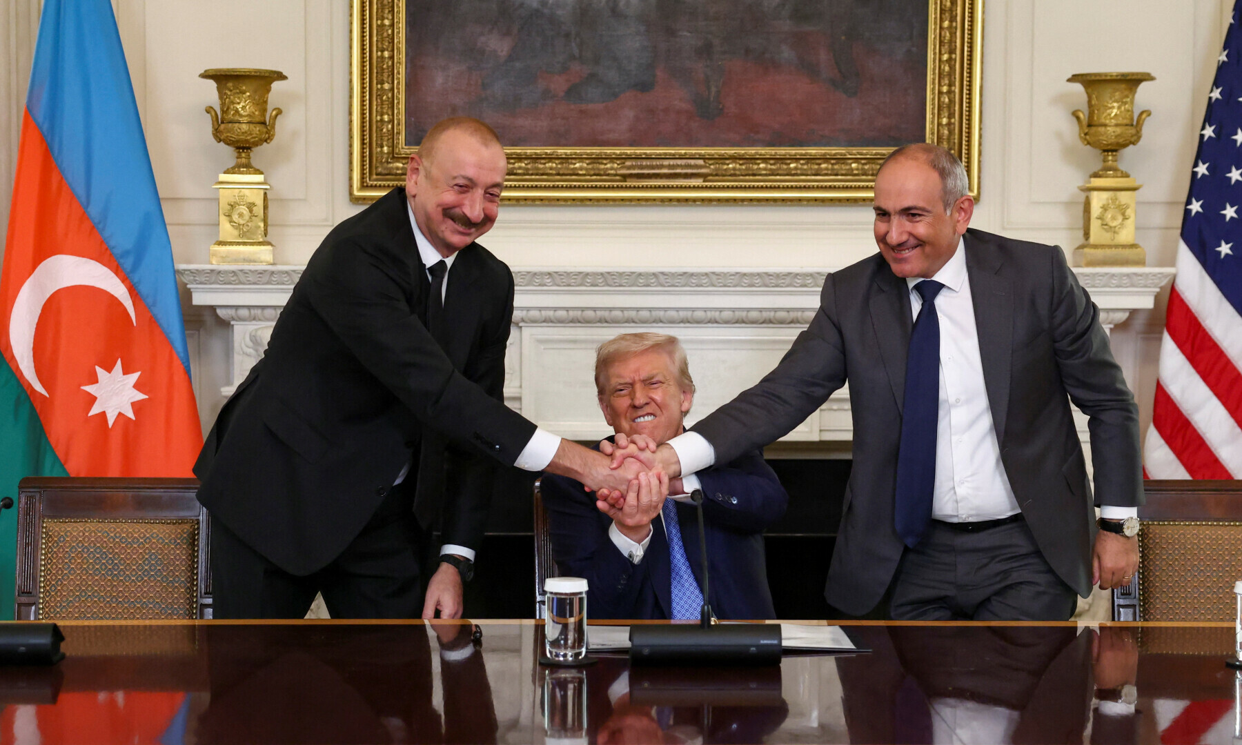 US President Donald Trump holds the hands of Azerbaijan’s President Ilham Aliyev and Armenia’s Prime Minister Nikol Pashinyan as they shake hands between each other during a trilateral signing event, at the White House, in Washington, DC on Aug 8, 2025. — Reuters/Kevin Lamarque