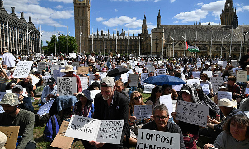 Protesters sit with placards supporting Palestine Action at a &lsquo;Lift The Ban&rsquo; demonstration in support of the proscribed group Palestine Action, calling for the recently imposed ban to be lifted, in Parliament Square, central London, UK on August 9. &mdash; AFP