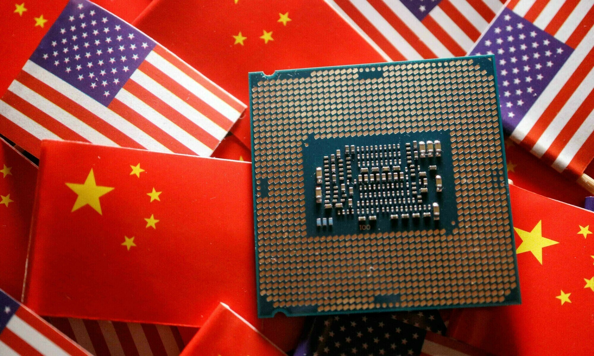 A central processing unit (CPU) semiconductor chip is displayed among flags of China and US, in this illustration picture taken on February 17. &mdash; Reuters/File