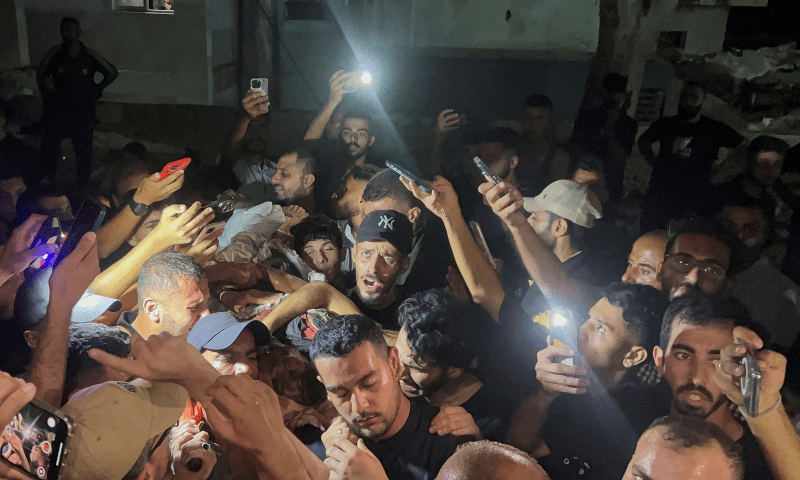  Palestinians hold the body of <em>Al Jazeera</em> journalist Anas Al-Sharif, who was killed by an Israeli strike, in Gaza City on August 11, 2025. &mdash; Reuters 