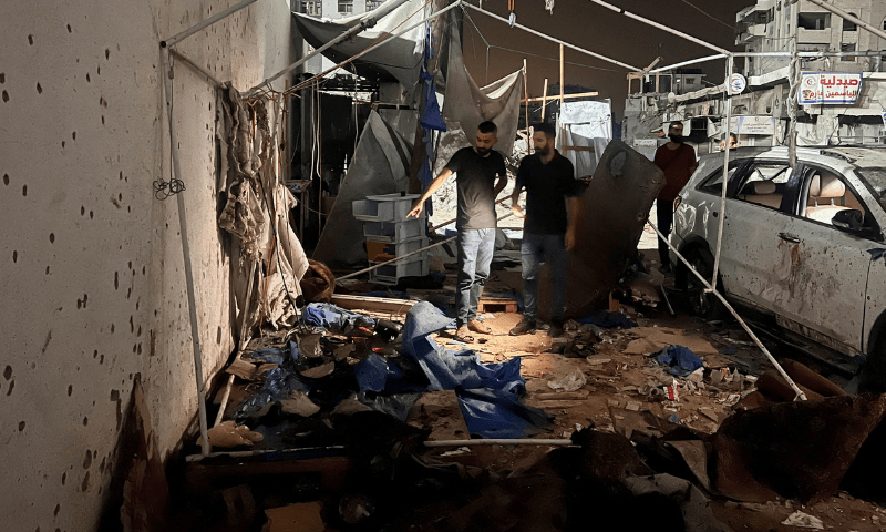  Palestinians inspect the site of an Israeli strike where <em>Al Jazeera</em> says its journalists Anas Al Sharif, Mohammed Qreiqeh and three photojournalists were killed, in Gaza City on August 11, 2025. &mdash; Reuters 