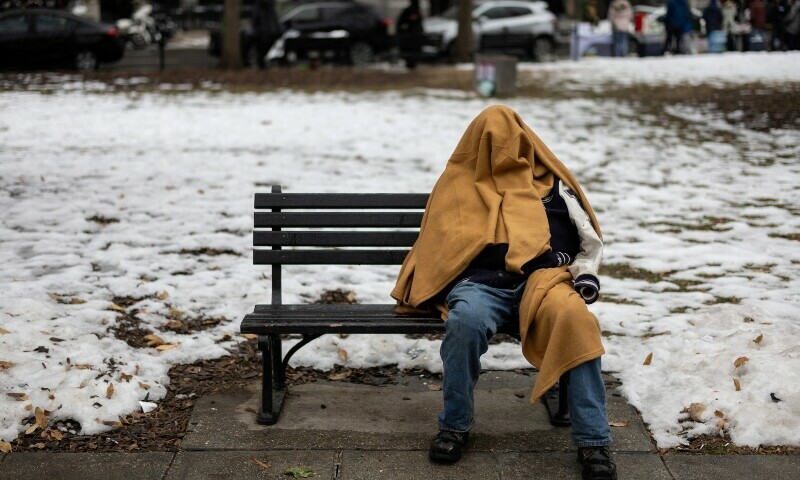 A homeless person sits on a bench in a park, ahead of the presidential inauguration of US President-elect Donald Trump, in Washington, US on January 18. &mdash; Reuters