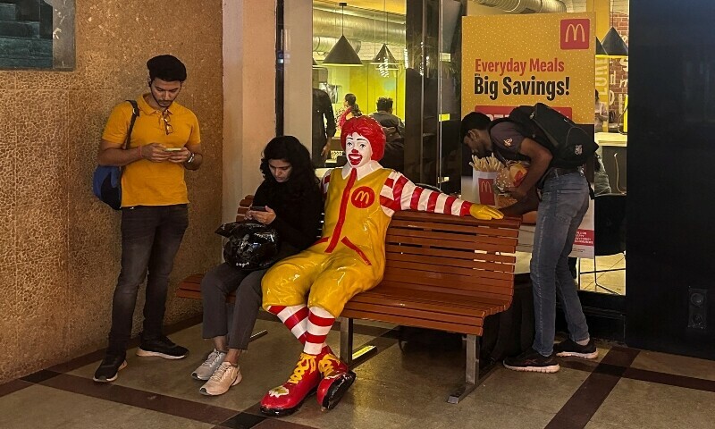 A person sits outside a McDonald&rsquo;s restaurant in Mumbai, India, February 26, 2024. &mdash; Reuters