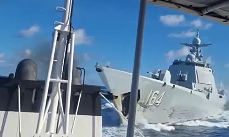 This handout video grab, released and taken on August 11, 2025, by the Philippine Coast Guard, shows a Chinese Navy vessel (R) following an incident with a Chinese Coast Guard ship in the South China Sea. &mdash; AFP