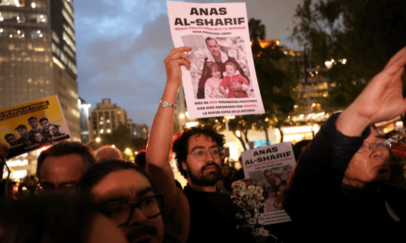  A demonstrator holds a poster with the photo of <em>Al Jazeera Arabic</em> correspondent Anas al-Sharif, who was killed along with his colleagues during an Israeli airstrike in Gaza on Sunday, amid the ongoing conflict between Israel and Hamas, at the Angel of Independence monument in Mexico City, Mexico on August 12, 2025. &mdash; Reuters 