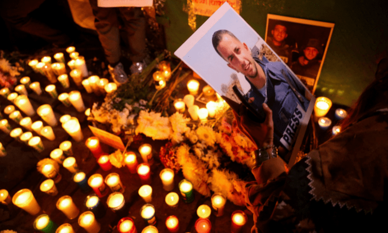  A demonstrator holds a photo of <em>Al Jazeera Arabic</em> correspondent Anas al-Sharif, who was killed along with his colleagues during an Israeli airstrike in Gaza on Sunday, amid the ongoing conflict between Israel and Hamas, at the Angel of Independence monument in Mexico City, Mexico on August 12, 2025. &mdash; Reuters 