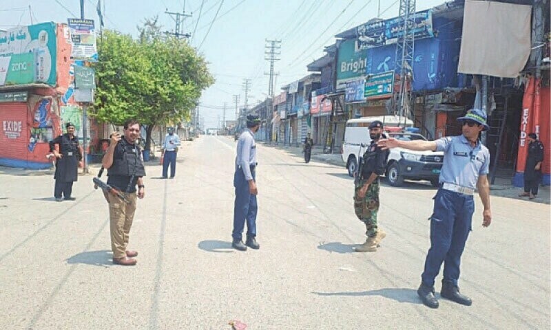 Security personnel guard the main bazaar in Khar during a 12-hour-long curfew in Bajaur.&mdash;Photo by Anwarullah Khan/File