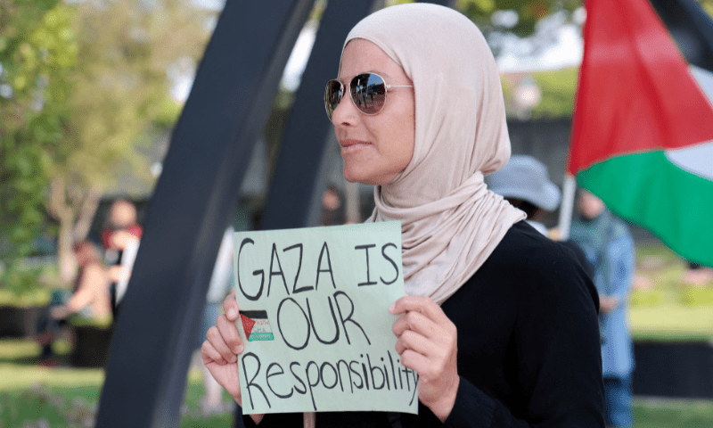  A Pro-Palestinian protestor holds a sign during a vigil for Gaza in Dearborn, Michigan, US on August 14, 2025. &mdash; Reuters 