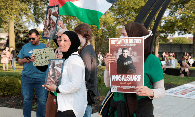  A pro-Palestinian protestor holds a sign in memory of <em>Al Jazeera</em> correspondent Anas al-Sharif, who was killed along with his colleagues during an Israeli airstrike in Gaza on Sunday, during a vigil for Gaza in Dearborn, Michigan, US on August 14, 2025. &mdash; Reuters 