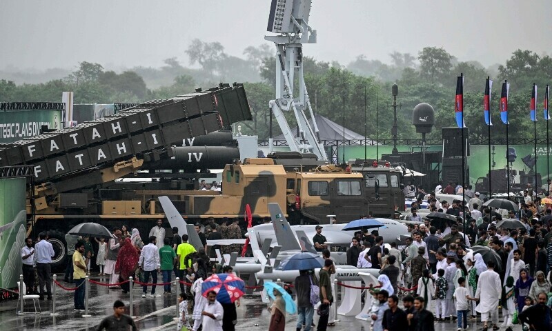People look at unmanned combat aerial vehicles and the Fatah-I missile system on display at a military exhibition during Independence Day celebrations in Islamabad on August 14, 2025. &mdash; AFP