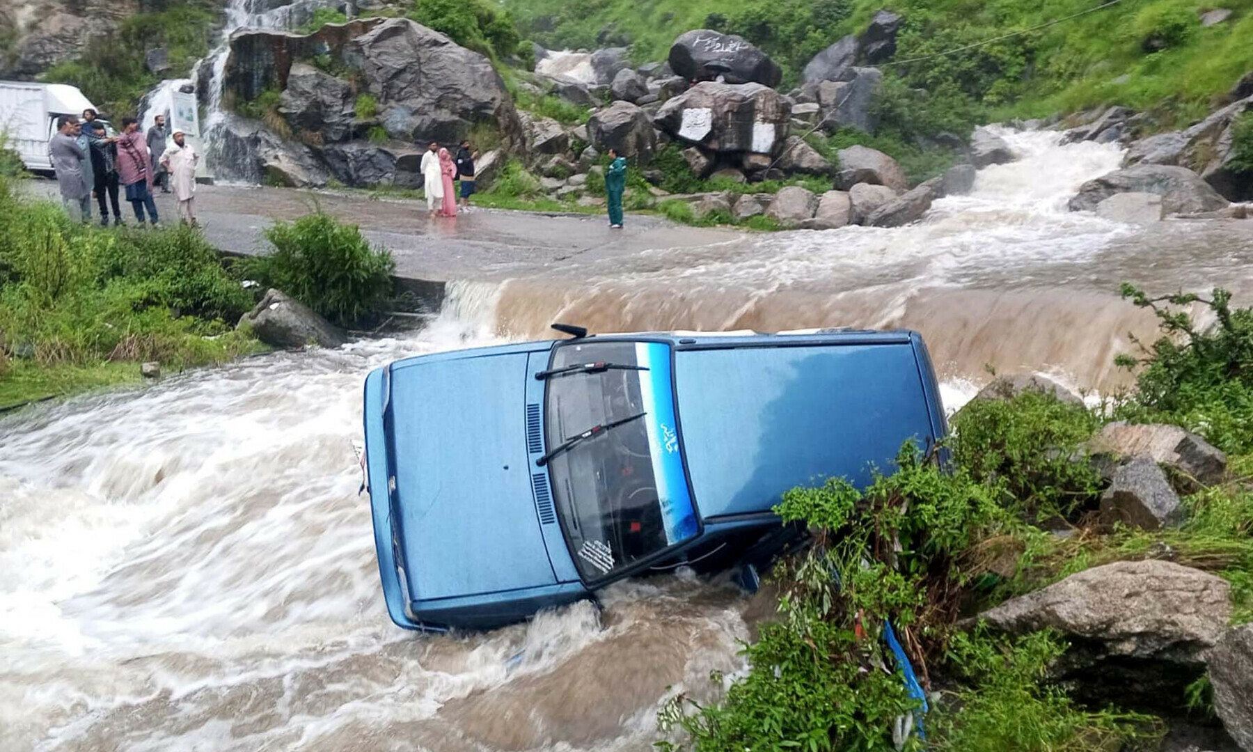  A car was swept away in a flash flood in the Basian area of KP’s Mansehra on Aug 15, 2025. — PPI Images 