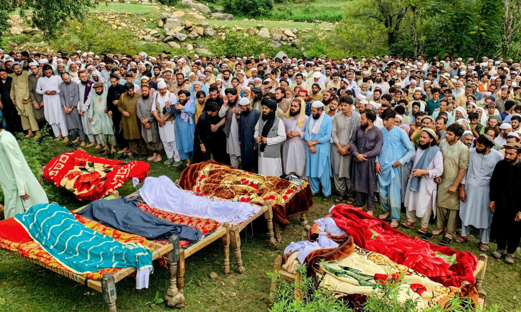  Mourners and locals offer funeral prayers for victims who died in incidents related to flash floods and monsoon rains in Salarzai Tehsil of KP’s Bajaur district on Aug 15, 2025. — AFP 