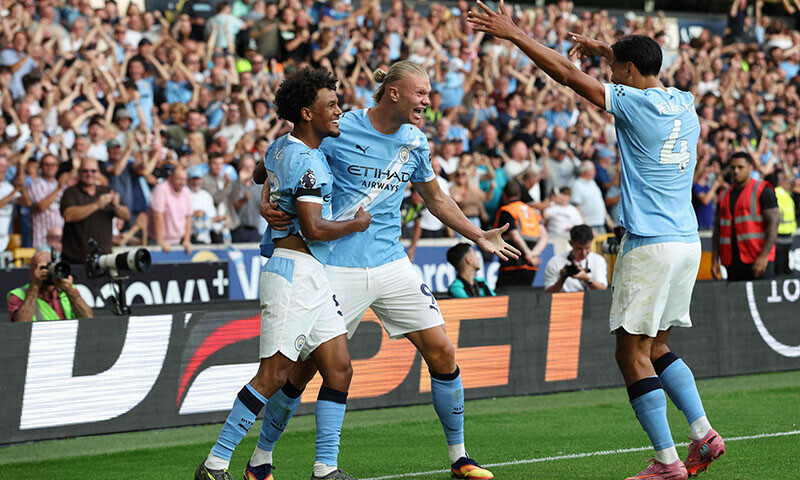 Manchester City’s Norwegian striker Erling Haaland celebrates scoring their third goal with Norwegian midfielder Oscar Bobb (L) and Dutch midfielder Tijjani Reijnders (R) during the English Premier League football match against Wolverhampton Wanderers at the Molineux stadium in Wolverhampton, central England on August 16. — AFP