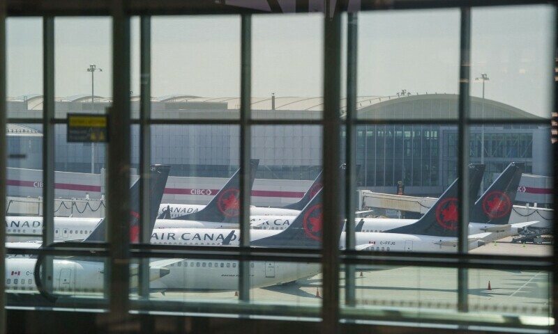 Air Canada airplanes stand on the tarmac at Pearson International Airport in Toronto on August 16. &mdash; AFP