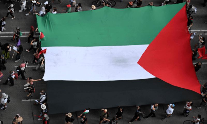  Members of the Global Movement for Palestine wave a giant Palestine flag during a rally against Israel&rsquo;s actions and the ongoing food shortages in the Gaza strip, in Mexico City on August 17, 2025. &mdash; AFP 
