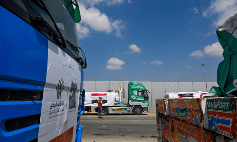  A man walks past trucks loaded with aid for Gaza, waiting on the Egyptian side of the Rafah crossing in Rafah on August 18, 2025. &mdash; AFP 