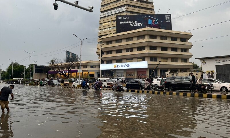 Rainwater inundates Dr Ziauddin Ahmed Road in Karachi on Tuesday. — Anushe Engineer