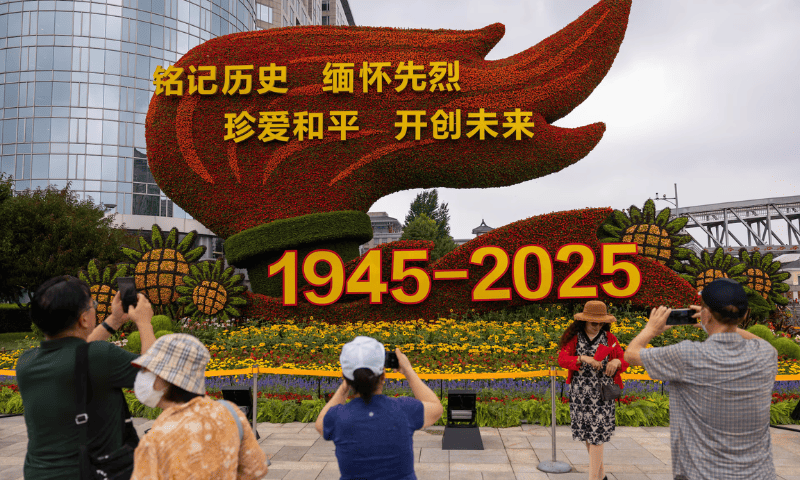 People take images of a flower installation commemorating the 80th anniversary of the end of World War Two, in Beijing, China, August 18, 2025. — Reuters