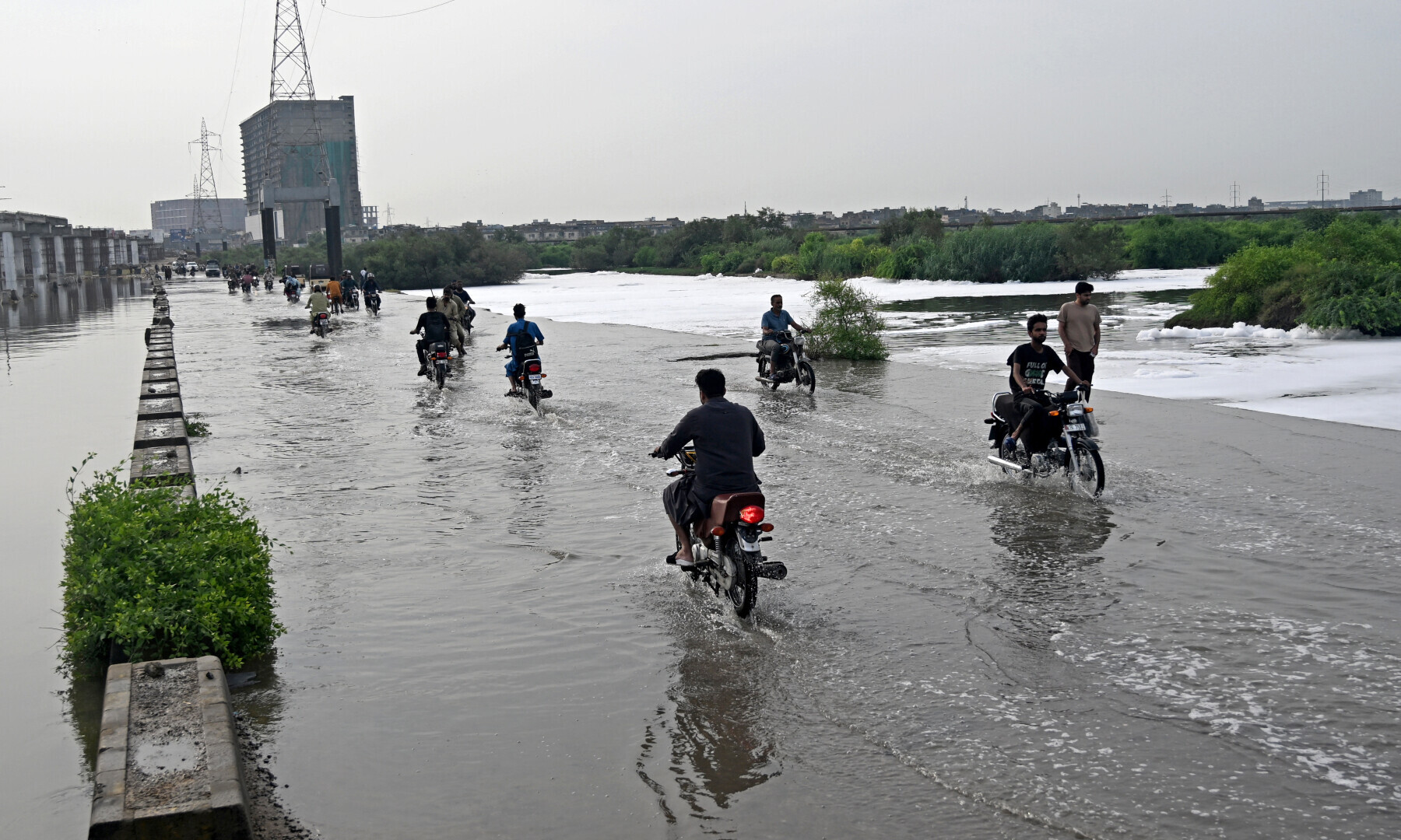 Motorists make their way through a flooded street after heavy monsoon rains in Karachi on Aug 20, 2025. — AFP
