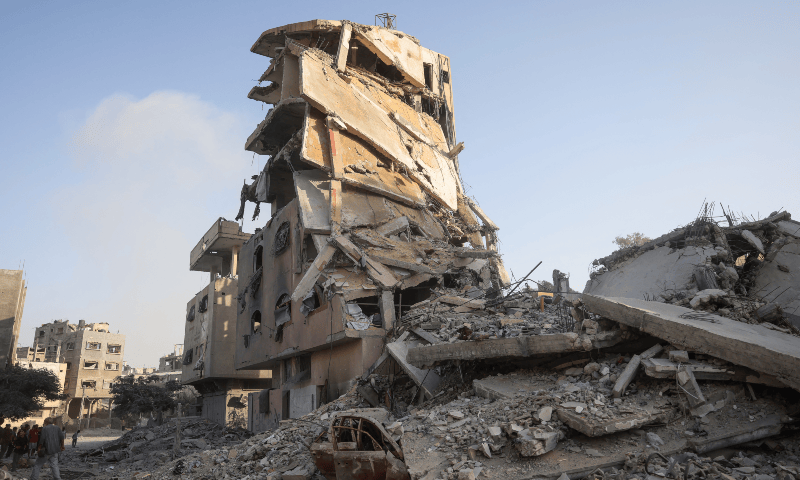  Palestinians gather at the site of Israeli air strikes on a six-storey building in the Saftawi neighbourhood west of Jabalia in the northern Gaza Strip on Aug 19, 2025. &mdash; AFP 