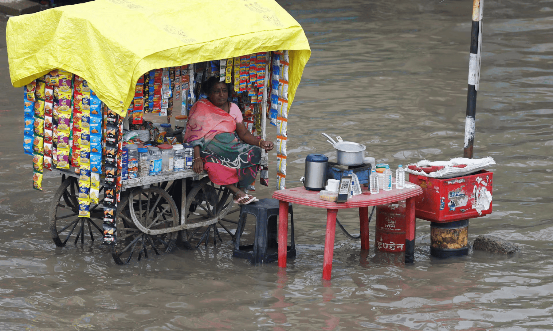  A woman vendor sits in her shop cart, as streets are flooded after torrential rains, in Ahmedabad, India on June 19, 2025. &mdash; Reuters 