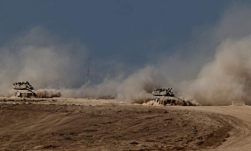 Israeli tanks manoeuvre on the Israeli side of the border with Gaza on August 20. — Reuters