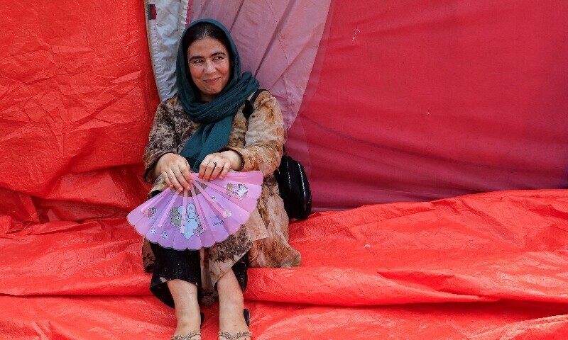 Afghan citizen Zarina, 30, who is jobless, takes shelter at a public park in Islamabad, Pakistan on August 15. &mdash;Reuters
