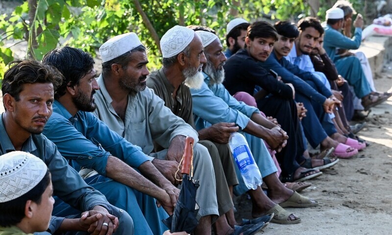 Flood victims wait to receive aid supplies at a relief camp in the Buner district of Khyber Pakhtunkhwa on August 19. &mdash; AFP