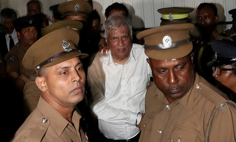 Sri Lanka&rsquo;s former President Ranil Wickremesinghe is escorted by prison and police officials as he leaves the Magistrate&rsquo;s Court in Colombo, Sri Lanka on August 22. &mdash; Reuters