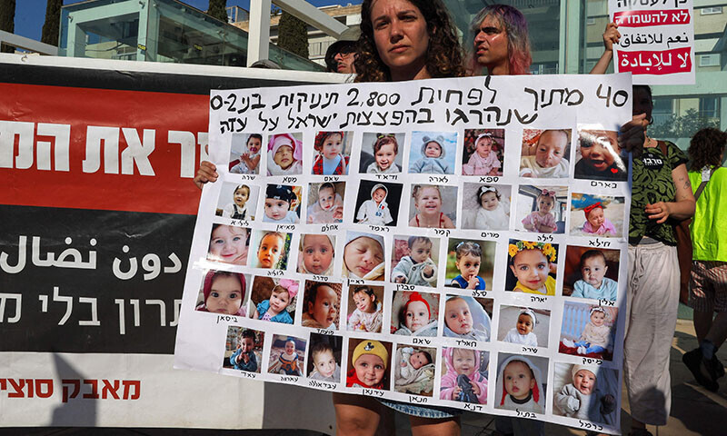 A demonstrator holds a placard that reads in Hebrew: &lsquo;40 out of 2800 babies (0-2 years-old) killed by Israeli bombing in Gaza&rsquo;, during a protest by Arab-Israelis and Israeli left-wing at HaBima square in Tel Aviv, Israel on August 23, against the ongoing conflict and catastrophic humanitarian situation in the Gaza Strip. &mdash; AFP