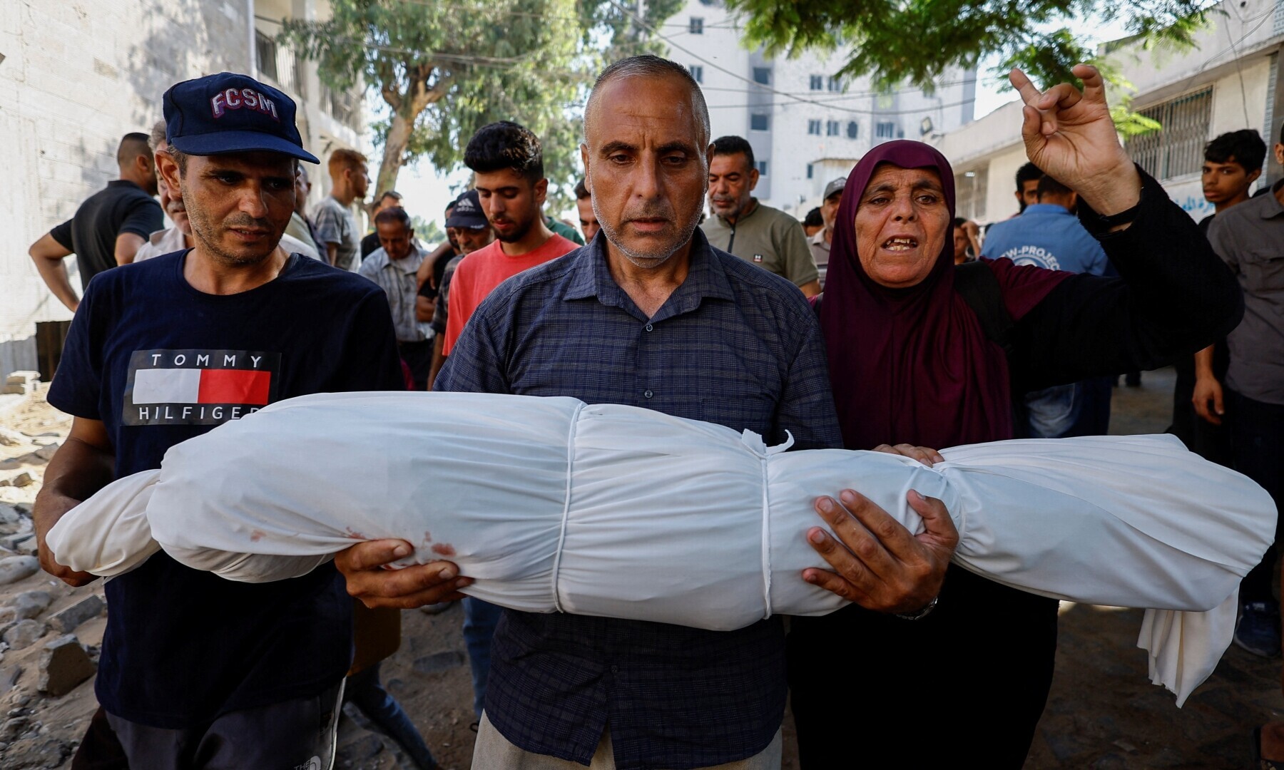 A mourner carries the body of Palestinian boy Hamada Abedrabo, who was killed in an Israeli strike, according to medics, at Al-Shifa Hospital in Gaza City, on August 24, 2025. — Reuters/Mahmoud Issa