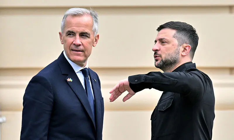 Ukrainian President Volodymyr Zelensky (R) and Canadian Prime Minister Mark Carney leave after a press conference following talks at Mariyinsky Palace in Kyiv, Ukraine on August 24. &mdash; AFP