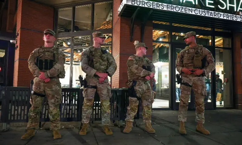 National Guard Members patrol 14th street, working with Washington DC Metro police on August 24, 2025 in Washington, DC. &mdash; AFP