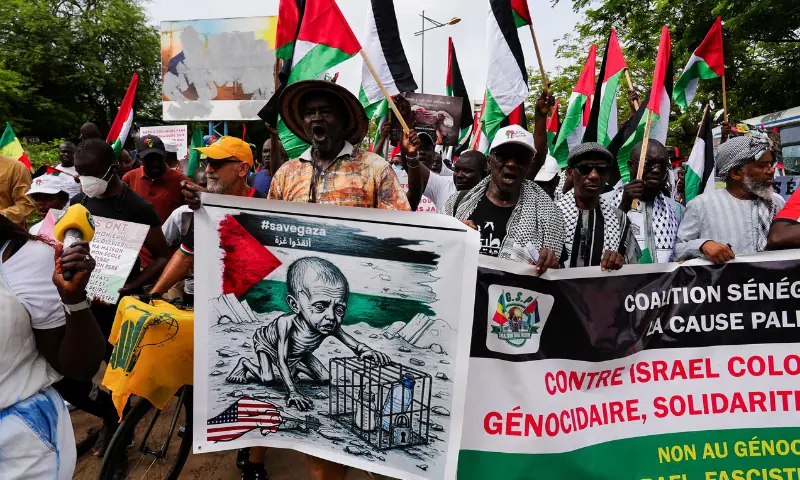  People hold banners during a protest in solidarity with Palestinians and Gaza, organised by a civil society group, in Dakar, Senegal on August 24, 2025. &mdash; Reuters 