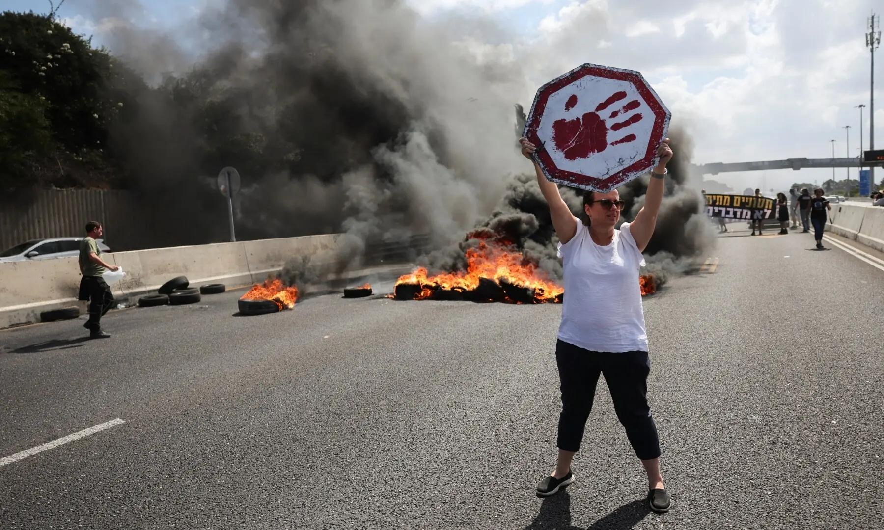  A protester holds a sign during a demonstration demanding the immediate end of the offensive and the release of all hostages who were kidnapped during the October 7, 2023 attack, in Tel Aviv, Israel on Aug 26, 2025. &mdash; Reuters/Nir Elias 
