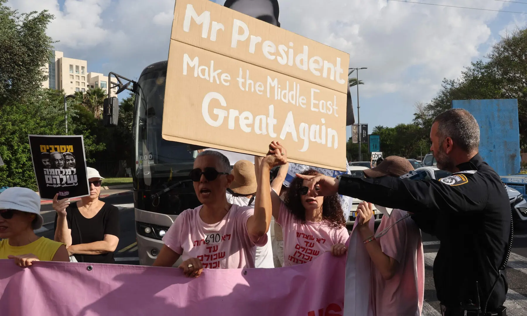  An Israeli police officer tries to move protesters from the middle of the road during a demonstration organised by the families of the Israeli hostages taken captive in the Gaza Strip since October 2023, calling for action to secure their release and a ceasefire in the offensive against Hamas in Tel Aviv on Aug 26, 2025. &mdash; Jack Guez / AFP 