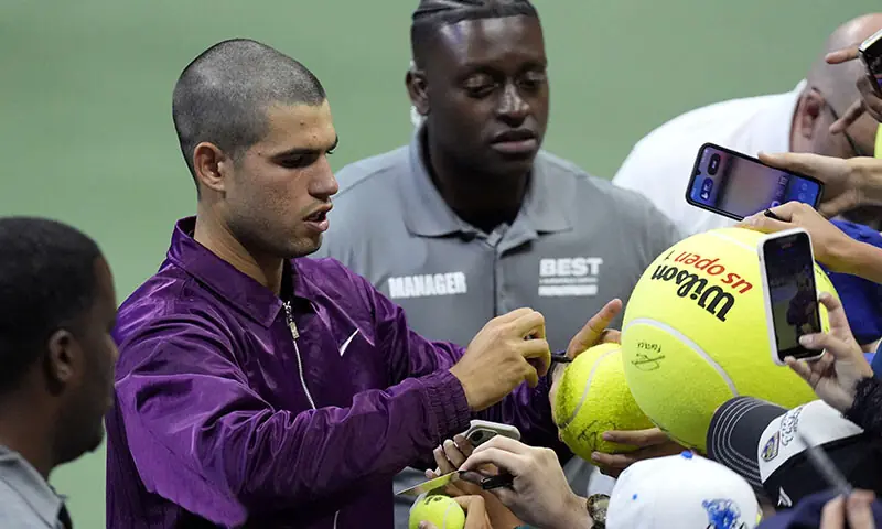 Spain&rsquo;s Carlos Alcaraz signs autographs for fans after winning his first round match against Reilly Opelka of the US. &mdash; Reuters