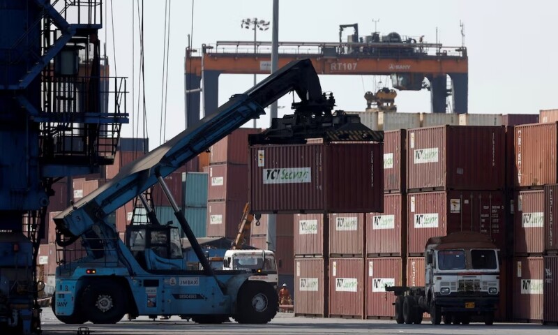 A mobile crane carries a container at Deendayal Port in Kandla, in the western state of Gujarat, India on April 5. &mdash; Reuters
