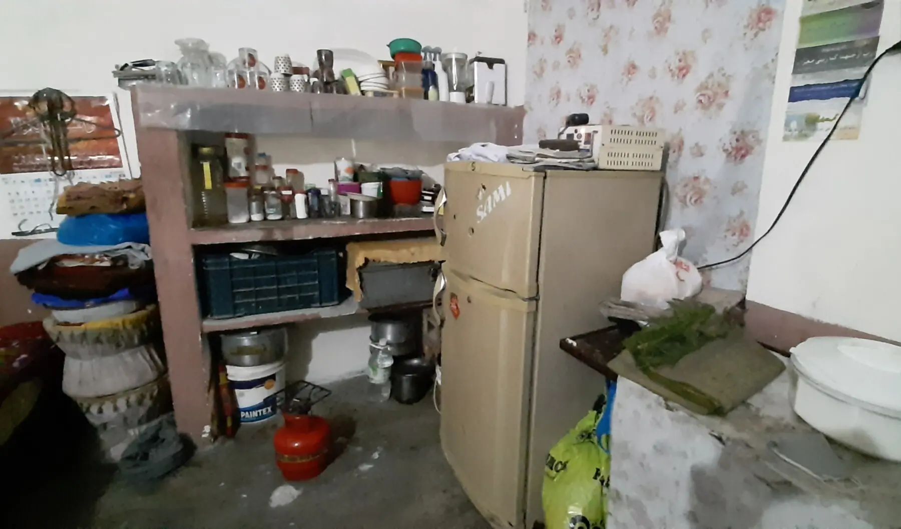 Domestic electrical appliances owned by a household in Peer colony. A second-hand fridge bought by the resident working as a housemaid from her employer on instalments.