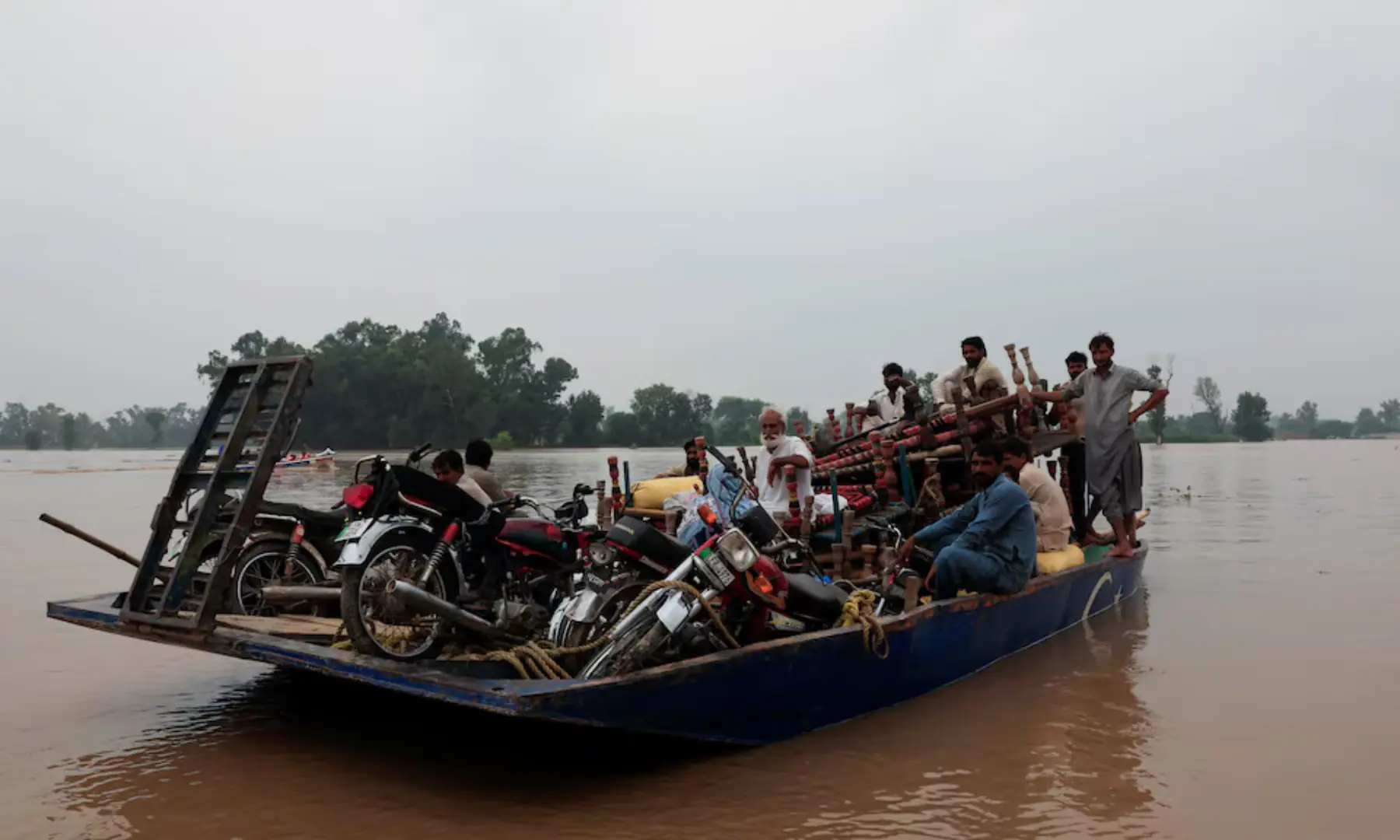 Residents travel with their belongings on a boat as they head towards higher ground, following the monsoon rains and rising water level of the Sutlej River, in Chanda Singh Wala village near the Pakistan-India border in Kasur district of the Punjab province, Pakistan August 29. 2025&mdash; Reuters